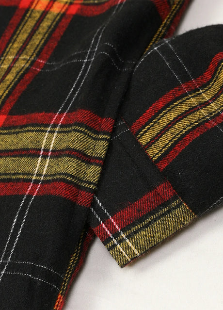 Close-up of the seam pocket of ebony gold men's workwear flannel shacket with hood