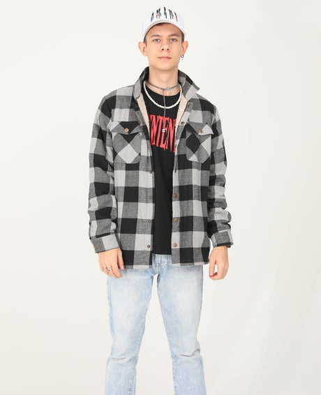 A boy who wears a checkered grey flannel shacket