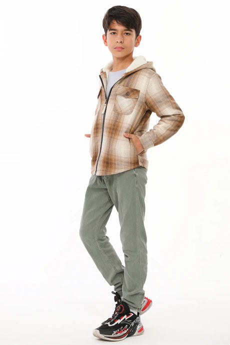 A boy with two hands in pocket wearing khaki flannel jacket