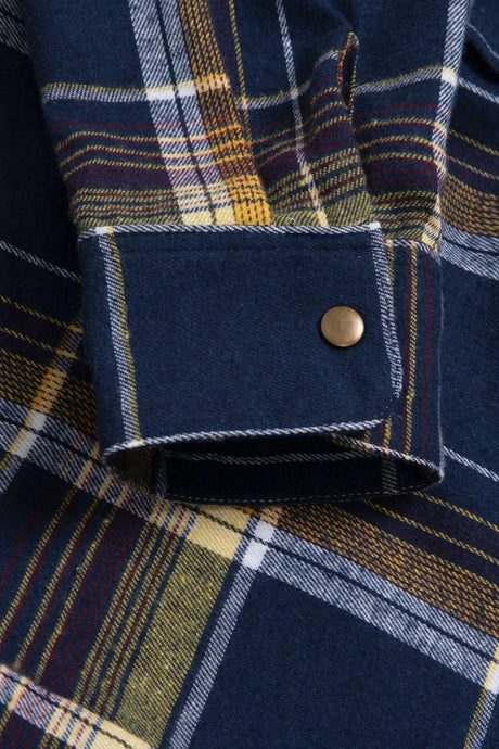 Close-up of the cuff of electric navy men's snap front plaid western flannel shirt