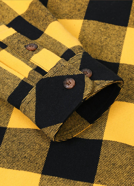 Close-up of the cuff of yellow black men's stalwart cotton flannel plaid shirt