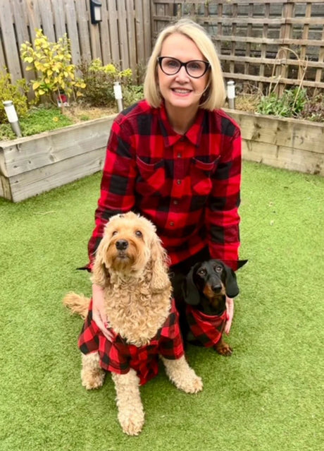 A lady and her dogs wearing our red plaid flannel