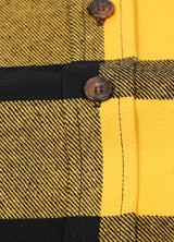 Close-up of the button of yellow black men's heavyweight flannel shirt