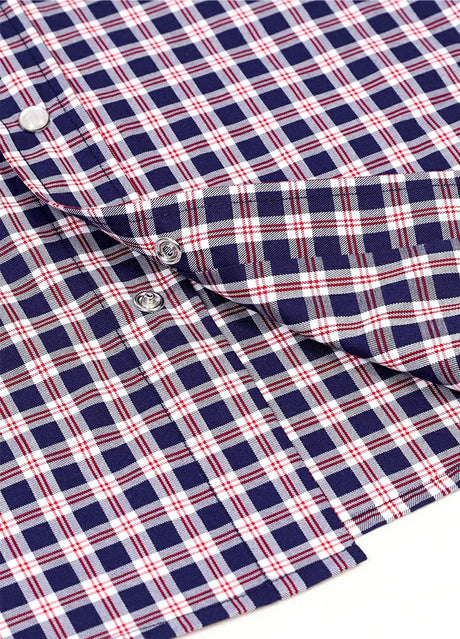 Detailed close-up of pearl snap on kids navyberry short-sleeve shirt