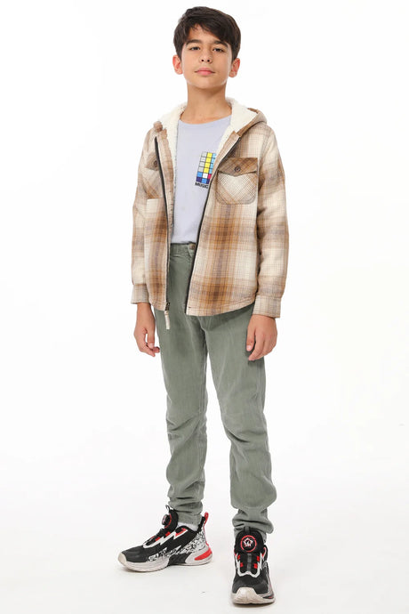 A standing boy wearing a khaki flannel jacket