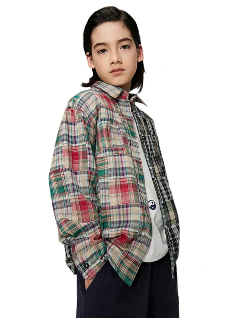 Side view of boy wearing a classic patchwork flannel plaid shirt