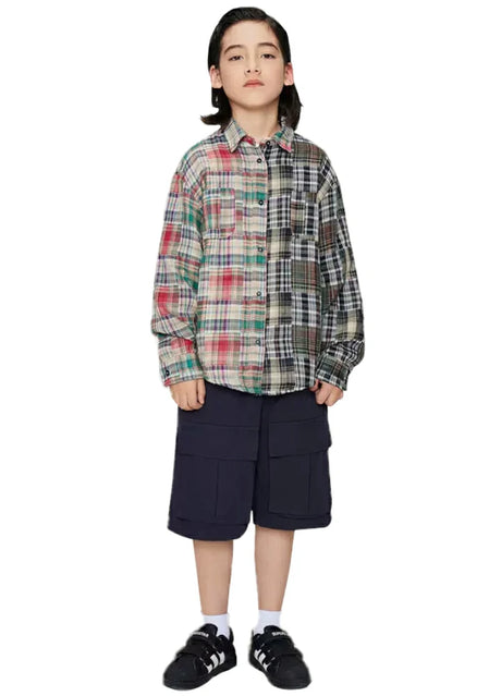 Boy who wears a classic pathwork flannel shirt with red and black stitching