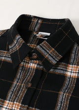 Close-up of the lapel of dark chocolate men's warm stalwart cotton plaid shirt 