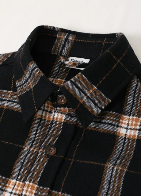 Close-up of the lapel of dark chocolate men's warm stalwart cotton plaid shirt 