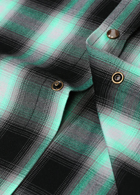 Detailed view of the snap button of turquoise men's soft western plaid vest