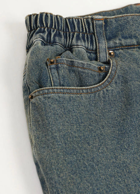 Detail of elastic waist and hand pocket on men's flannel lined jeans