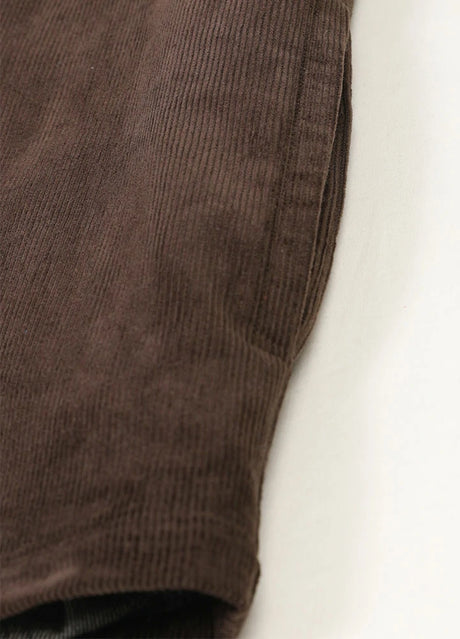 Detail of hand pocket on men's chocolate corduroy shirt jacket