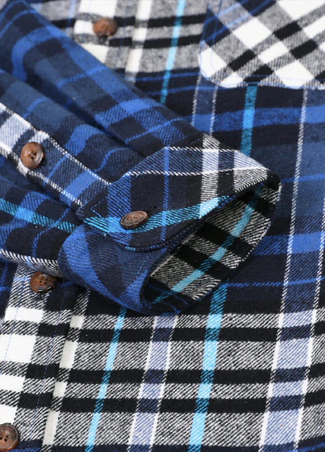 Close-up of the cuff of royal blue men's stalwart cotton flannel plaid shirt