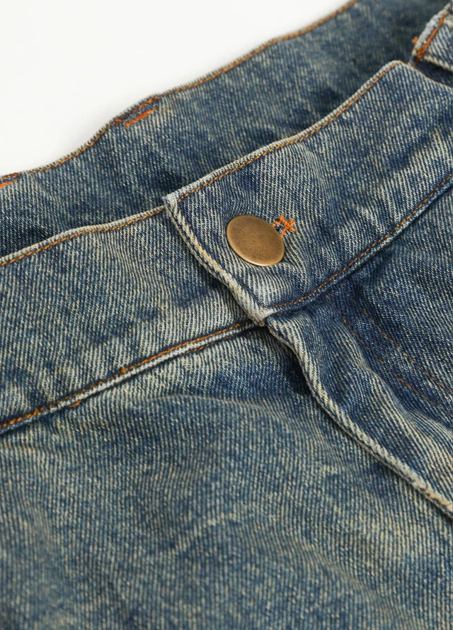 Close-up of button on men's flannel lined jean