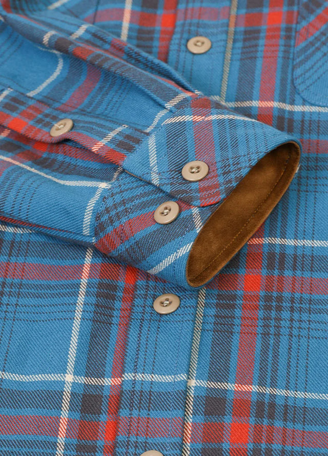 Close-up of the cuff of peacock blue men's warm rugged ridge outdoor flannel shirt