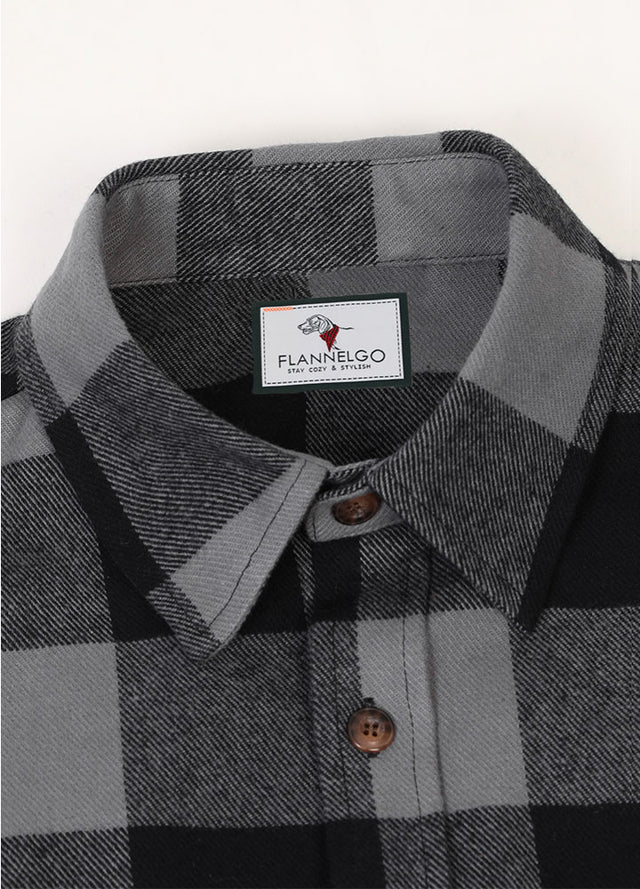 Close-up of the lapel of gray men's warm rugged stiff flannel plaid shirt