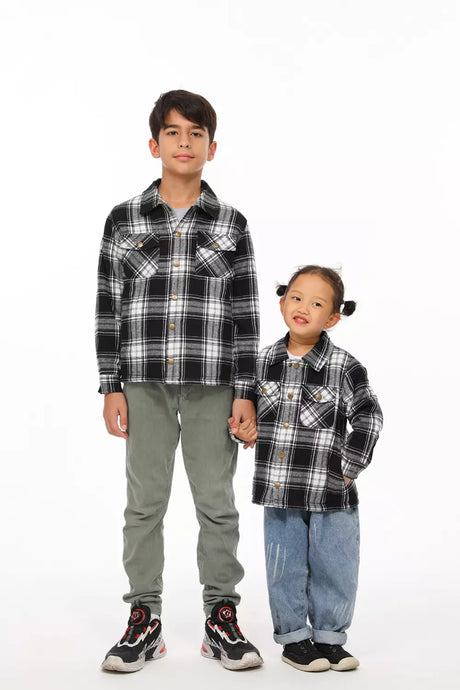 Brother and sister in black white flannel shackets