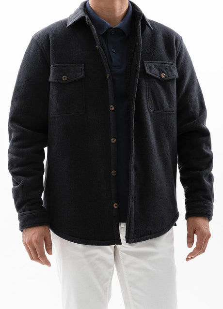 A man in a twill black men's cozy fleece shirt jacket with sherpa lining 