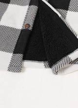 Close-up of the hem of buffalo black white men's seam pockets sherpa lined shirt jacket