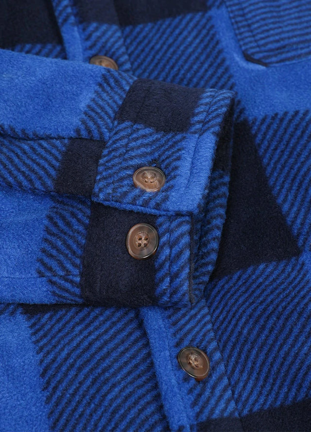 Close-up of the cuff of buffalo blue black men's sherpa lined shirt jacket with button closure