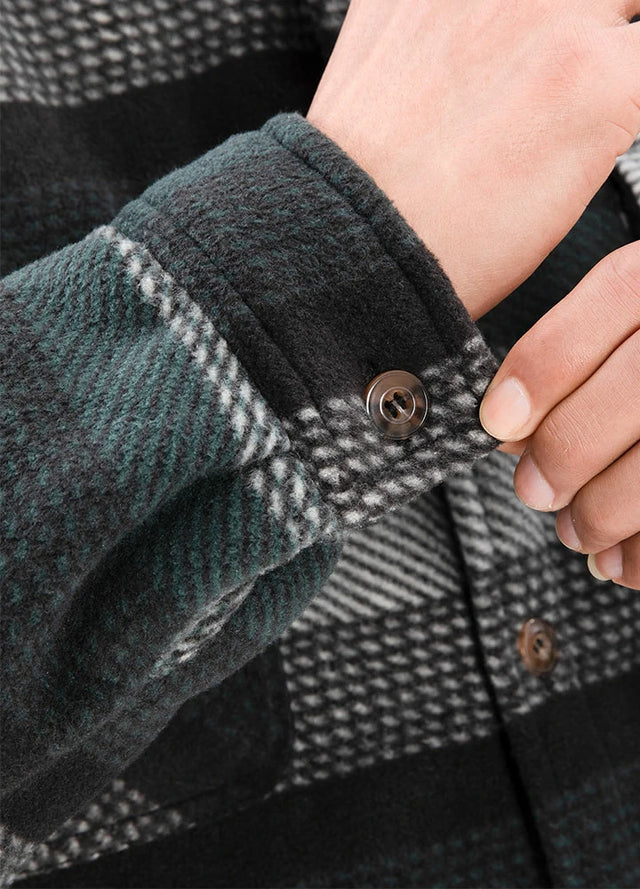 Detailed view of the cuff of green stripe sherpa lined plaid shirt jacket for men