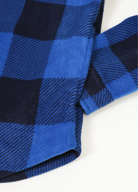 Close-up of the seam pocket of buffalo blue black men's sherpa lined plaid shirt jacket with button closure