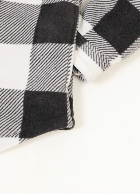 Close-up of the seam pocket of buffalo black white men's sherpa lined plaid shirt jacket with button closure