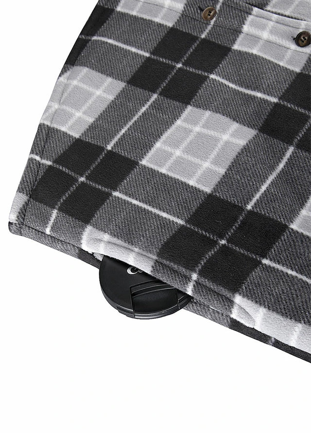 Close-up of the seam pocket of black grey men's sherpa lined plaid shirt jacket with button closure