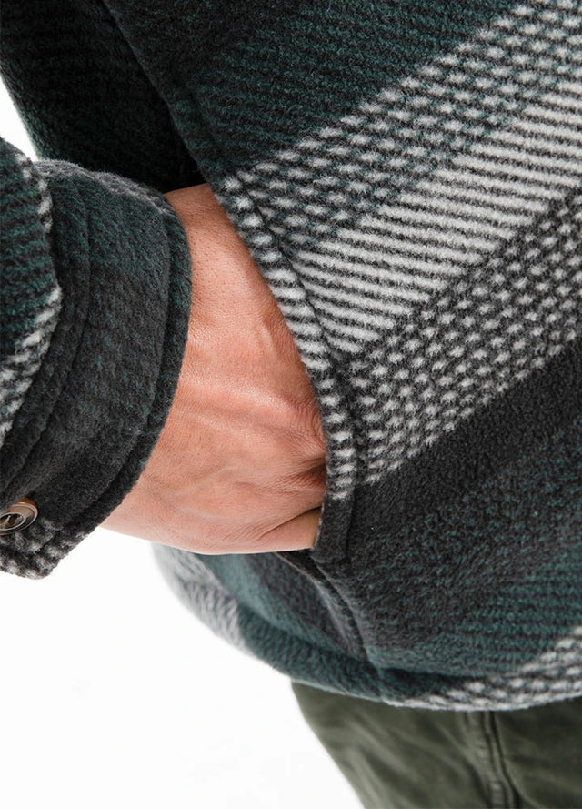 Detailed view of the seam pocket of green stripe sherpa lined plaid shacket for men