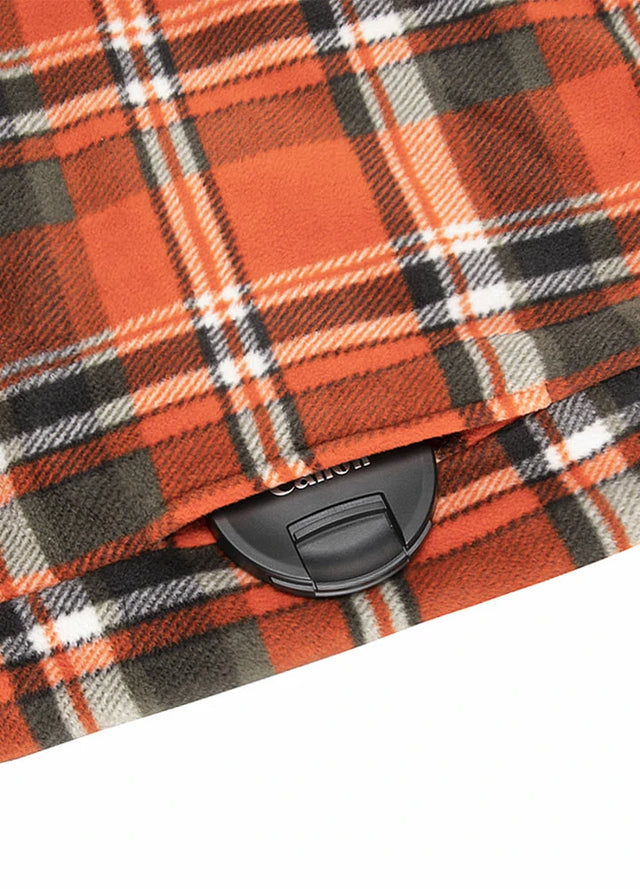 Close-up of the seam pocket of orange plaid men's sherpa lined plaid shirt jacket with button closure