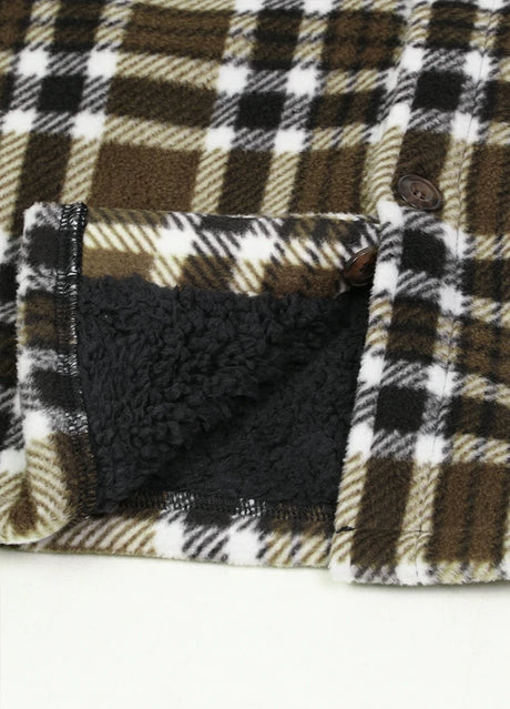 Close-up of the hem of brown white men's seam pockets sherpa lined shirt jacket