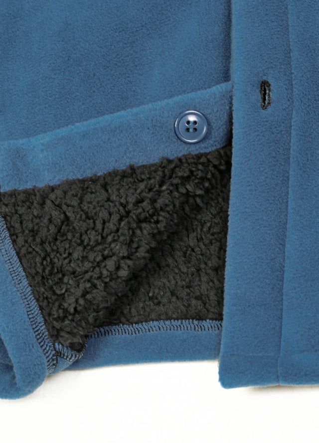 Close-up of the hem of the light blue men's button sherpa lined shirt jacket