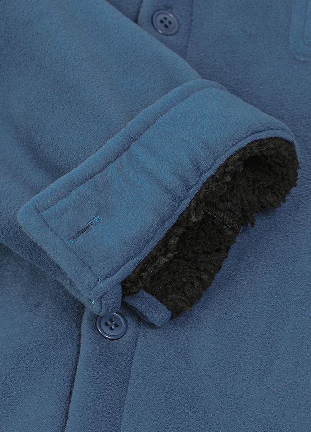 Close-up of the cuff of light blue men's seam pocket winter fleece shirt jacket