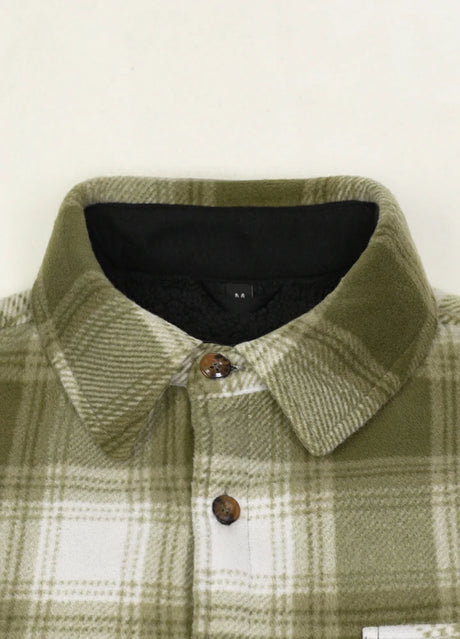 Close-up of the lapel of misty woodland men's button plaid shirt jacket with sherpa lining