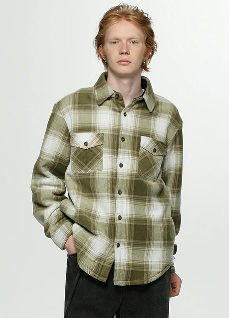 A man in a misty woodland cozy sherpa lined shacket with seam pockets