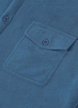 Close-up of the pocket of light blue men's winter sherpa fleece lined shacket 