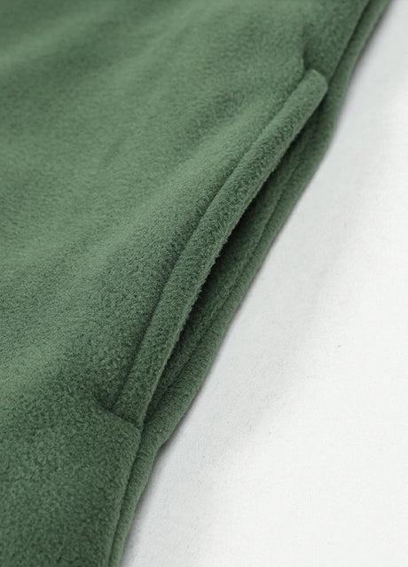 Close-up of the seam pocket of lark green men's button closure winter fleece jacket