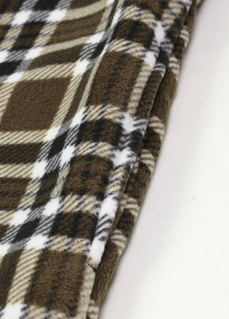 Close-up of the seam pocket of brown white men's sherpa lined plaid shirt jacket with button closure