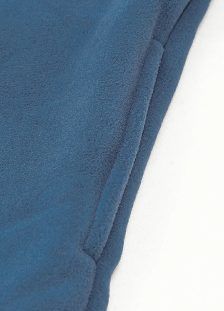 Close-up of the seam pocket of light blue men's button closure winter fleece jacket