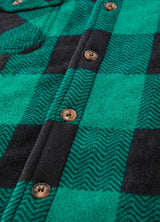 Close-up of the button of green men's seam pocket sherpa lined shacket