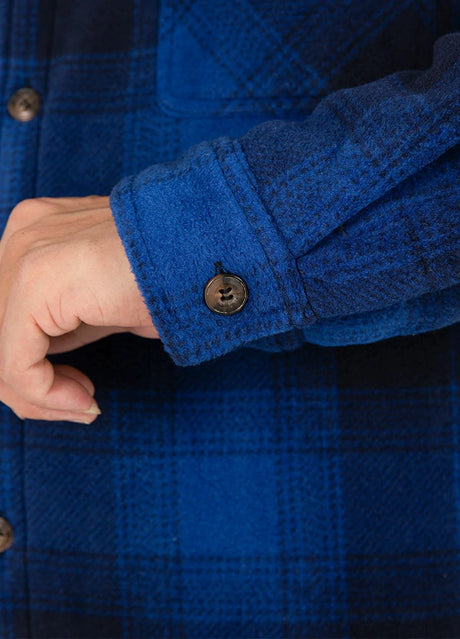 Close-up of the cuff of navy black sherpa lined plaid shirt jacket for men