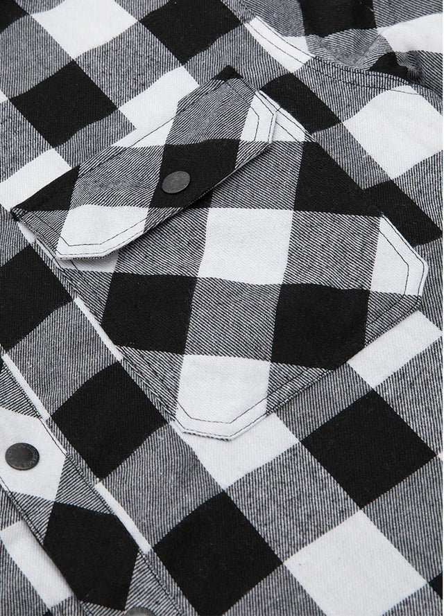 Close-up of the pocket of black white plaid men's quilted lined plaid flannel shirt jacket