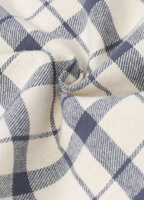 Detailed close-up of cozy fabric on kid's beige long-sleeve western shirt