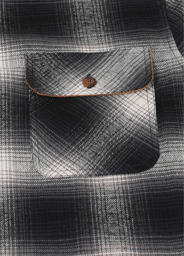 Close-up of the pocket of gray white men's midweight plaid flannel shirt