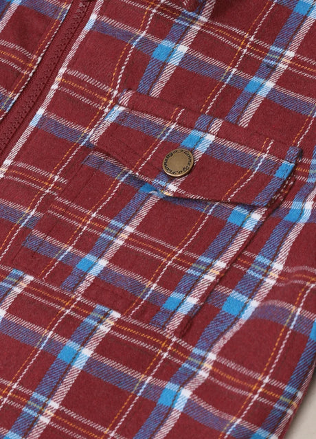 Detail of front snap button pocket on kid's burgundy flannel jacket