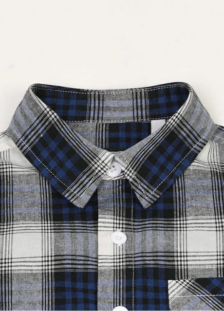 Detail of buttoned front closure on kids soft flannel short sleeve shirt