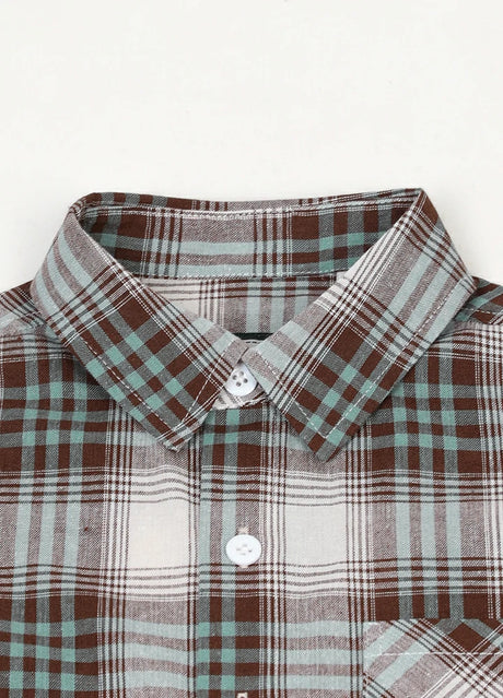 Zoomed-in view of buttoned front closure on kids short sleeve flannel shirt