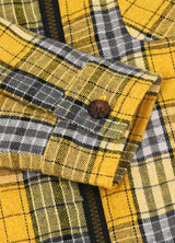 Detailed view of cuff on boys light yellow flannel jacket