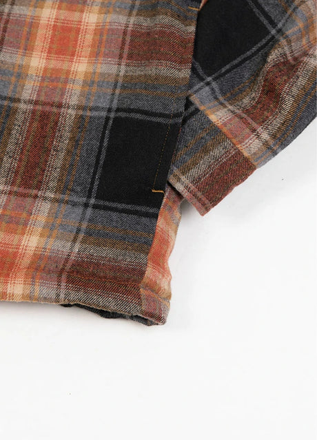 Close-up of the seam pocket of brown men's quilted lined brushed flannel jacket