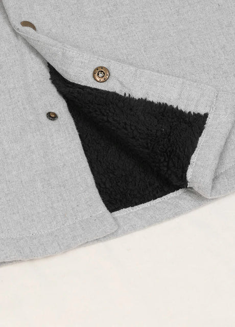 Close-up of the hem of ash men's warm flannel jacket with sherpa lining